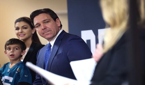 Republican presidential candidate Florida Governor Ron DeSantis, with his family by his side, speaks to guests during the Scott County Fireside Chat at the Tanglewood Hills Pavilion on December 18, 2023 in Bettendorf, Iowa. CREDIT: Scott Olson/Getty Images