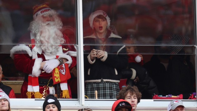 L-R: Austin Swift in Santa suit, Taylor Swift; Jamie Squire/Getty Images