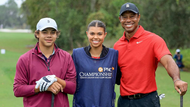 Tiger Woods of The United States poses for a picture on the first tee with his son Charlie Woods and his daughter Sam Woods who was caddying for Tiger during the final round of the PNC Championship at The Ritz-Carlton Golf Club on December 17, 2023 in Orlando, Florida. -- David Cannon/Getty Images