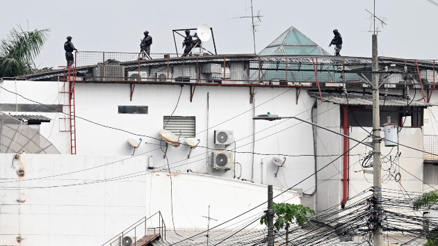 An Ecuadorean police squad approach the premises of Ecuador's TC television channel after unidentified gunmen burst into the state-owned television studio live on air on Jan. 9, 2024, in Guayaquil, Ecuador. (Marcos Pin/AFP via Getty Images)