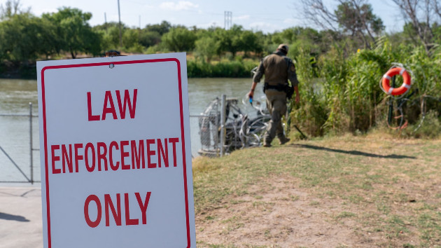 In this Aug. 24, 2023, file photo, law enforcement officials patrol the edge of Eagle Pass' Shelby Park, in Eagle Pass, Texas. -- Suzanne Cordeiro/AFP via Getty Images, FILE