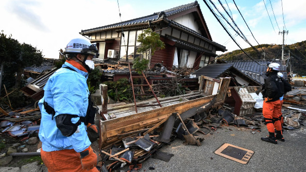 Firefighters inspect collapsed wooden houses in Wajima, Ishikawa Prefecture, on Jan. 2, 2024, a day after a major 7.5 magnitude earthquake struck the Noto region in the prefecture in the afternoon. (Kazuhiro Nogi/AFP via Getty Images)