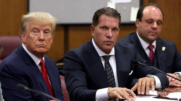 Former U.S. President Donald Trump sits with his attorneys Joe Tacopina and Boris Epshteyn inside the courtroom during his arraignment at the Manhattan Criminal Court April 4, 2023 in New York City. (Andrew Kelly-Pool/Getty Images)