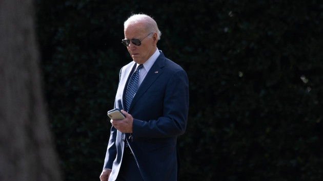 President Joe Biden checks a cell phone while walking to Marine One from the Oval Office at the White House, in Washington, D.C., Feb. 8, 2024. (Tom Brenner for The Washington Post via Getty Images)