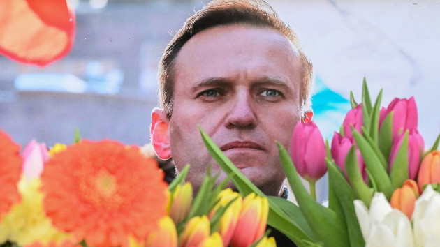 Flowers are seen placed around portraits of late Russian opposition leader Alexei Navalny, who died in a Russian Arctic prison, at a makeshift memorial in front of the former Russian consulate in Frankfurt am Main, western Germany, on Feb. 20, 2024. (AFP via Getty Images)
