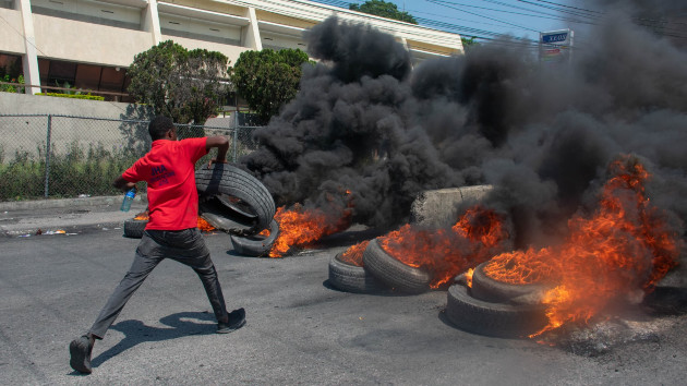 A protester burns tires during a demonstration following the resignation of its Prime Minister Ariel Henry, in Port-au-Prince, Haiti, on March 12, 2024. (Clarens Siffroy/AFP via Getty Images)
