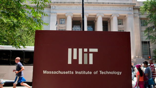 In this June 30, 2015, file photo, pedestrians walk near a sign in front of the William Barton Rogers Building at the Massachusetts Institute of Technology (MIT) campus in Cambridge, Massachusetts. -- Bloomberg via Getty Images, FILE