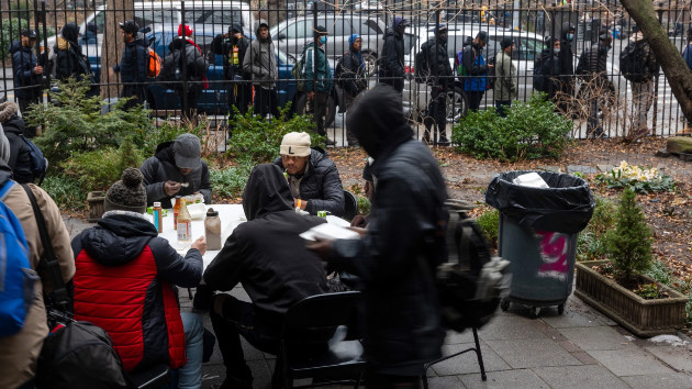 Newly arrived migrants receive an afternoon meal from Trinity Services and Food For the Homeless, across from Tompkins Square Park on Jan. 24, 2024 in New York City. (Spencer Platt/Getty Images)