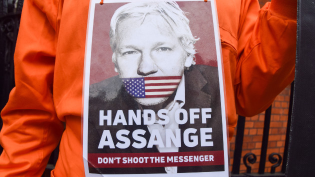 A protester stands with a placard in support of Julian Assange during the demonstration. Supporters of Julian Assange gathered outside the Embassy of Ecuador in Knightsbridge on the fifth anniversary of his incarceration in Belmarsh Prison. (Vuk Valcic/SOPA Images/LightRocket via Getty Images)