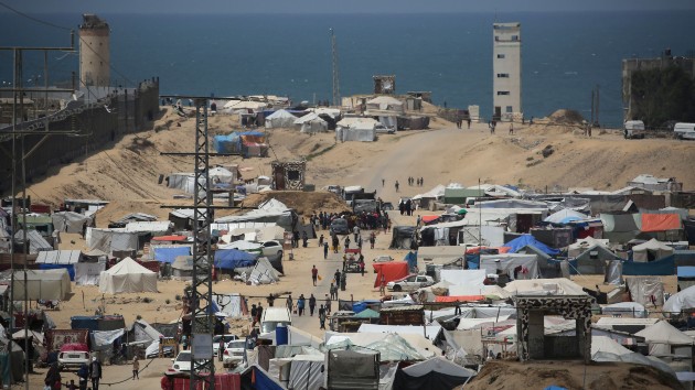 People walk in a camp for displaced people in Rafah in the southern Gaza Strip by the border with Egypt on April 28, 2024, amid the ongoing conflict between Israel and the Palestinian militant group Hamas. (AFP via Getty Images)