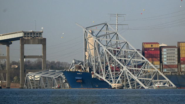 The collapsed Francis Scott Key Bridge lies on top of the container ship Dali in Baltimore, Maryland, on March 29, 2024. (Photo by Mandel NGAN / AFP)