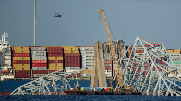 A crane works on the debris of the Francis Scott Key Bridge on March 29, 2024 in Baltimore. -- Kevin Dietsch/Getty Images