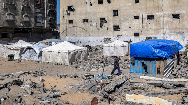 A man walks past tents and shacks erected by destroyed buildings in Rafah in the southern Gaza Strip, April 9, 2024. (AFP via Getty Images)