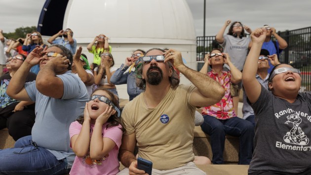 People watch the Annular Solar Eclipse with using safety glasses in Brownsville, Texas on Oct. 14, 2023. (Mike Gonzalez/Anadolu via Getty Images)