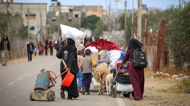 Displaced Palestinians in Rafah in the southern Gaza Strip carry their belongings as they leave following an evacuation order by the Israeli army on May 6, 2024, amid the ongoing conflict between Israel and the Palestinian Hamas movement. (Photo by -/AFP via Getty Images)