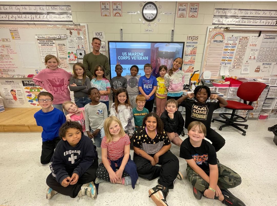 Mrs. Faxon invited Mr. Faxon to share his military experience with her class today! Her class “planted” flags outside th…