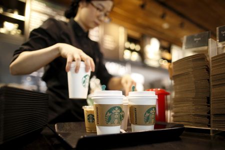 Starbucks to beef up store staffing, go slow on automation rollout