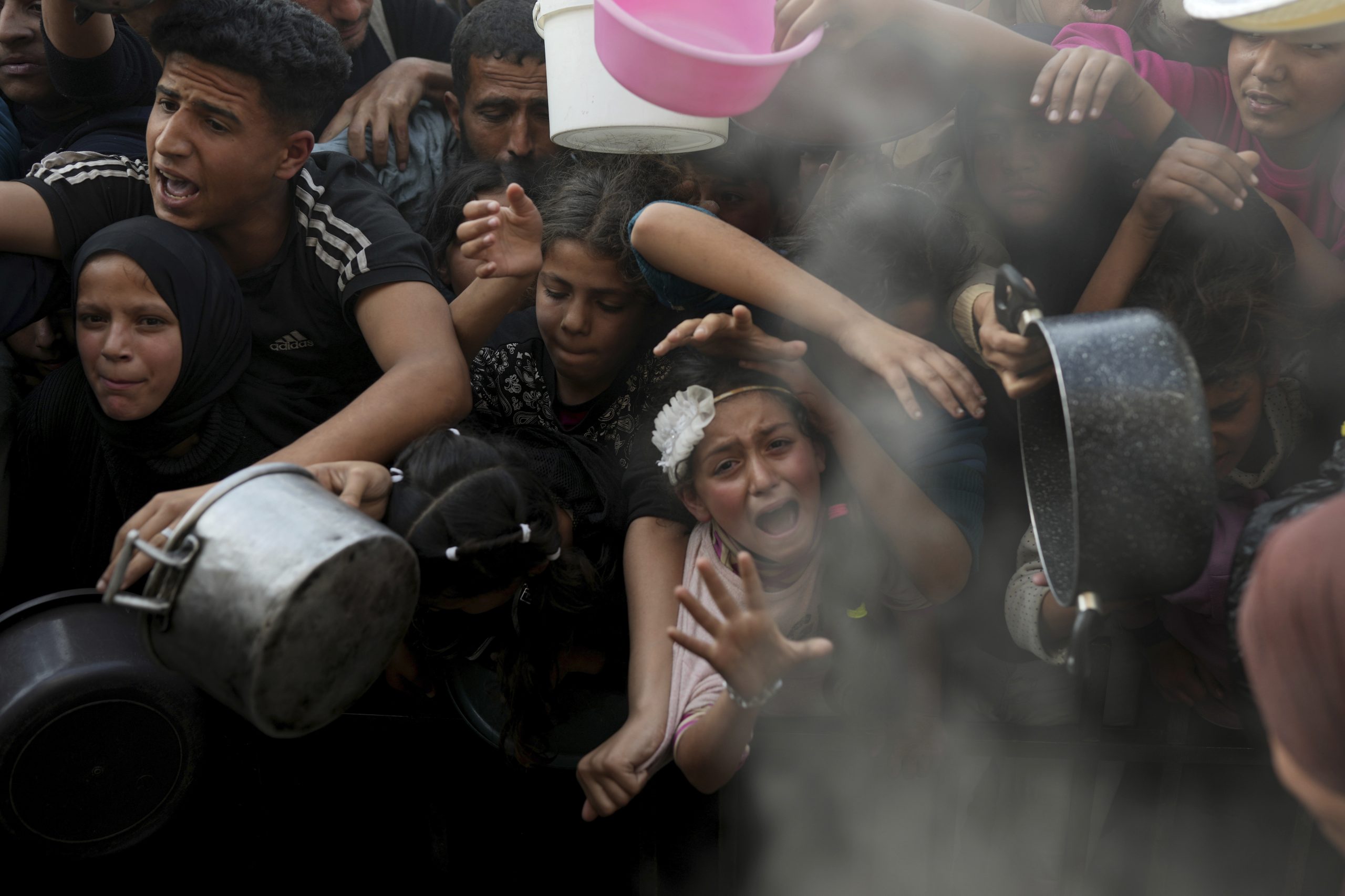 Desperate children and adults in Gaza struggle to get food as Israel blocks aid
