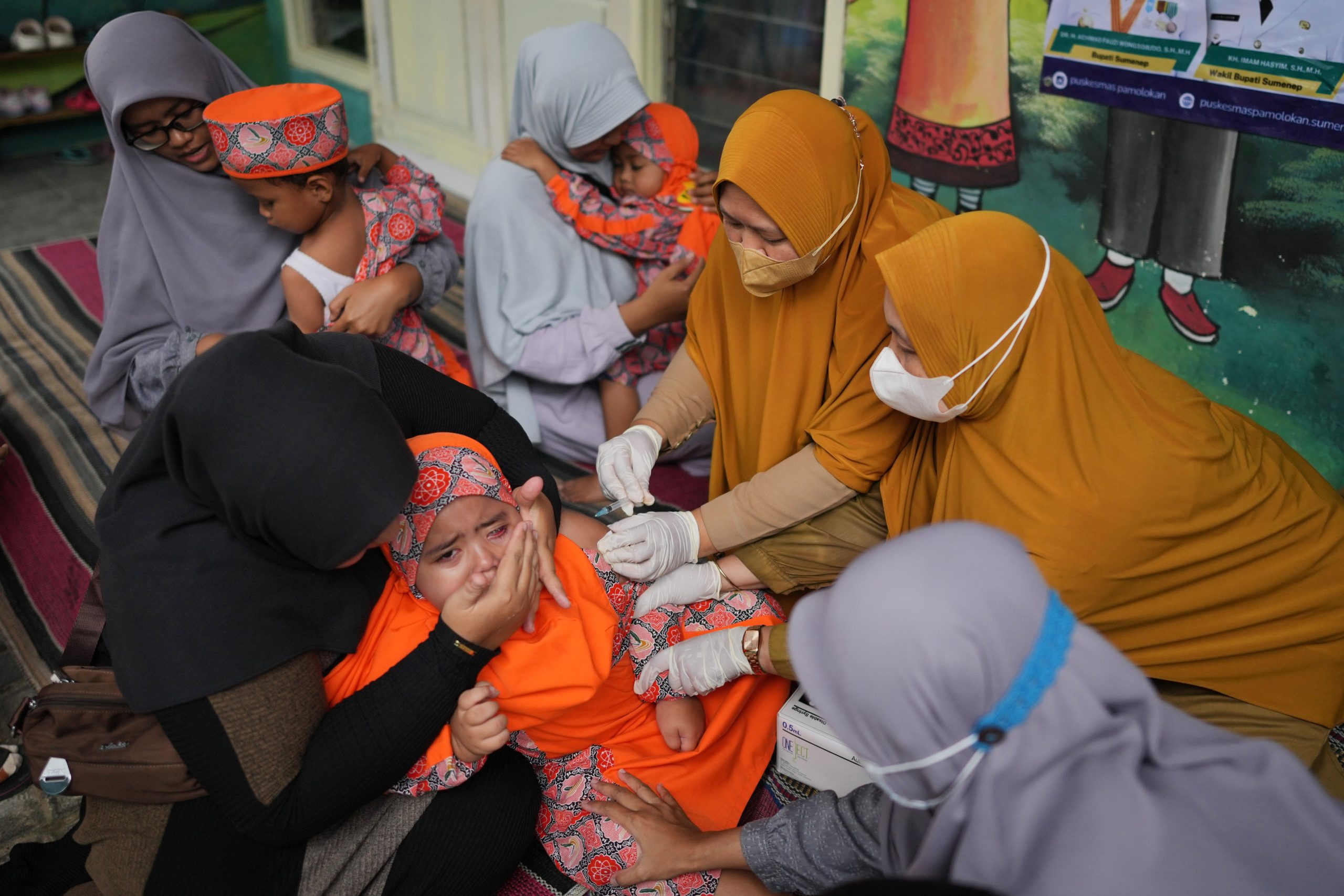 Photos show the efforts to curb a measles outbreak in Indonesia