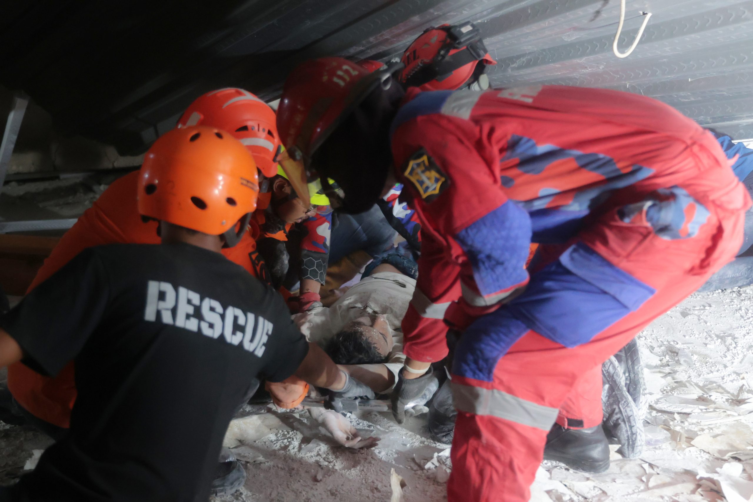 Rescuers run oxygen to survivors in Indonesia school building collapse that buried dozens