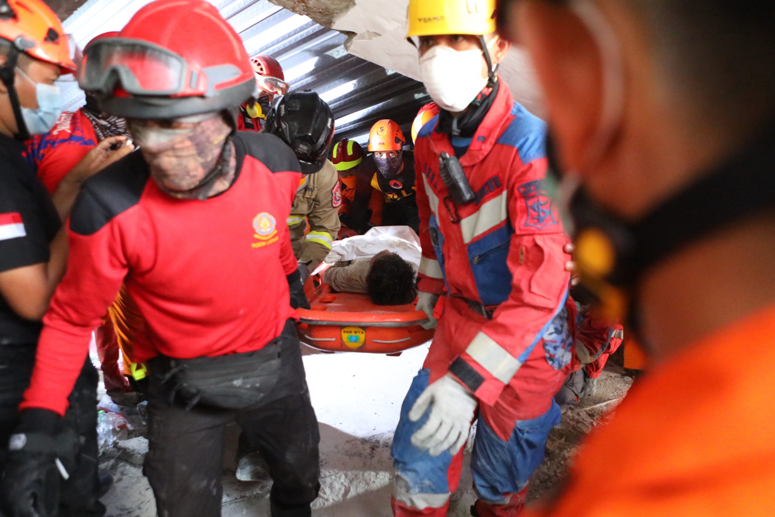 Rescuers chip away debris with hand tools to save those trapped in Indonesia school collapse