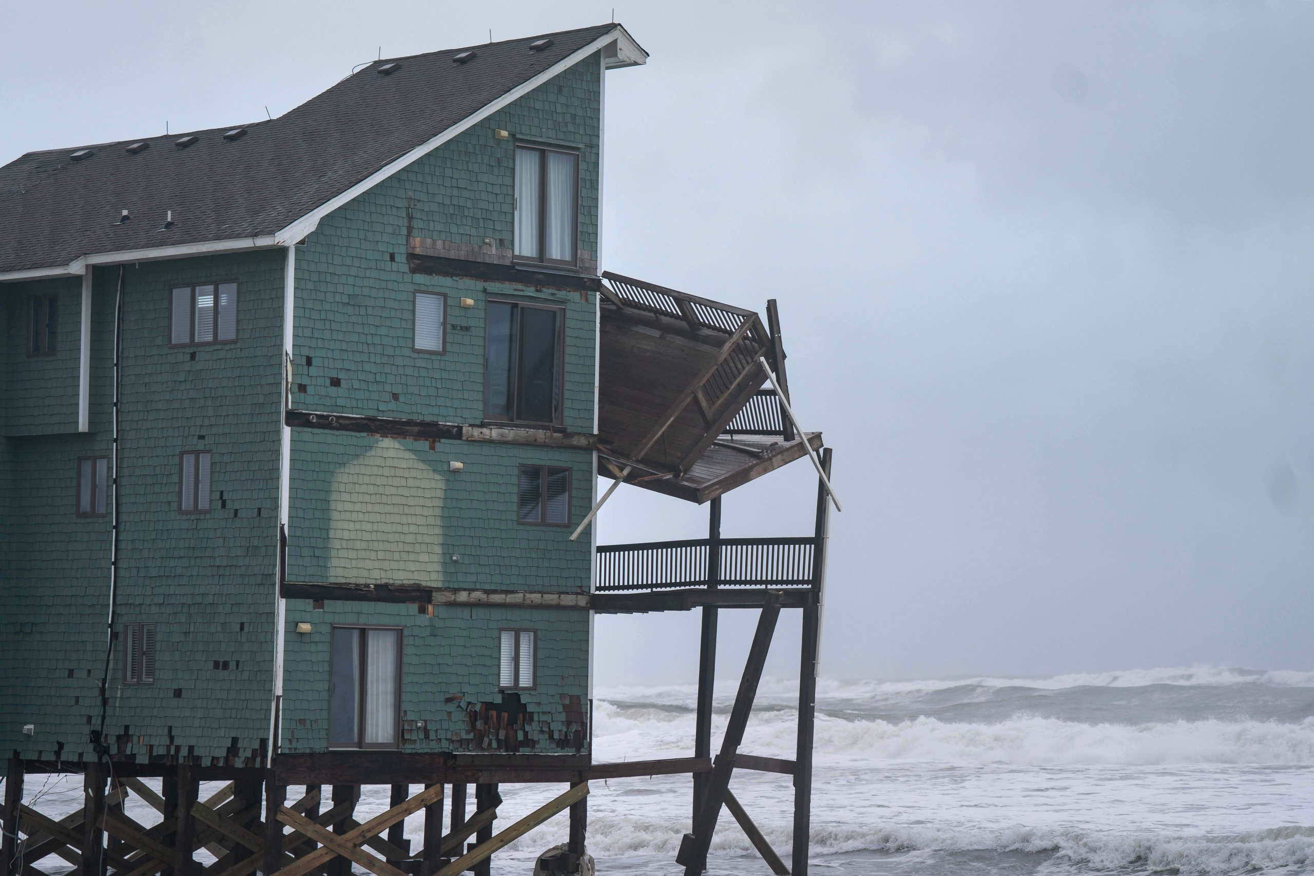 Dozens rescued as remnants of typhoon hits Alaska while nor’easter brings flooding to East Coast