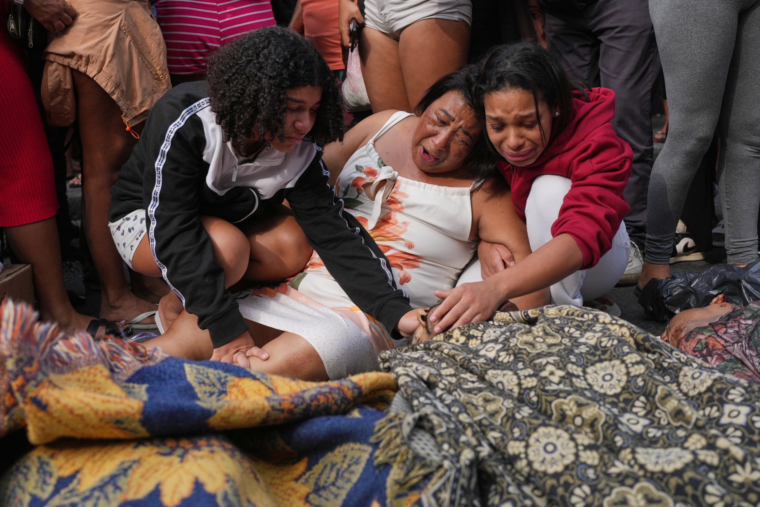 Brazilians in a Rio favela line up bodies after the city’s deadliest police raid
