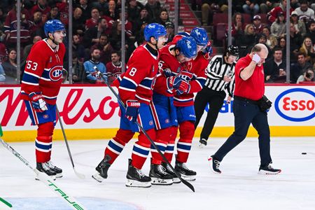 Canadiens F Alex Newhook helped off ice after collision with boards