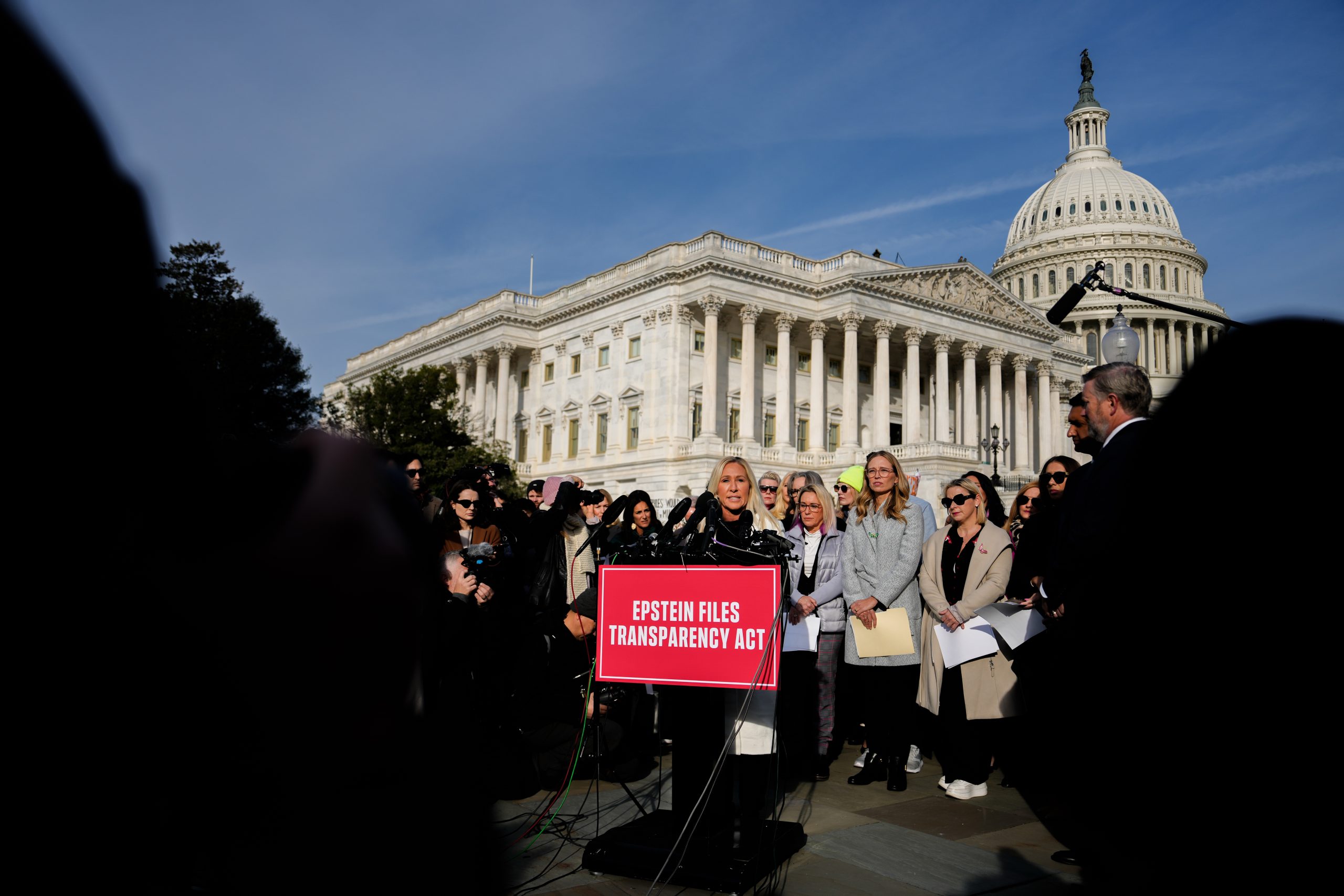 Photos of Marjorie Taylor Greene standing with Epstein survivors before the vote on Epstein files