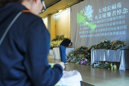 Hong Kong races to remove scaffolding nets blamed for fuelling deadly fire