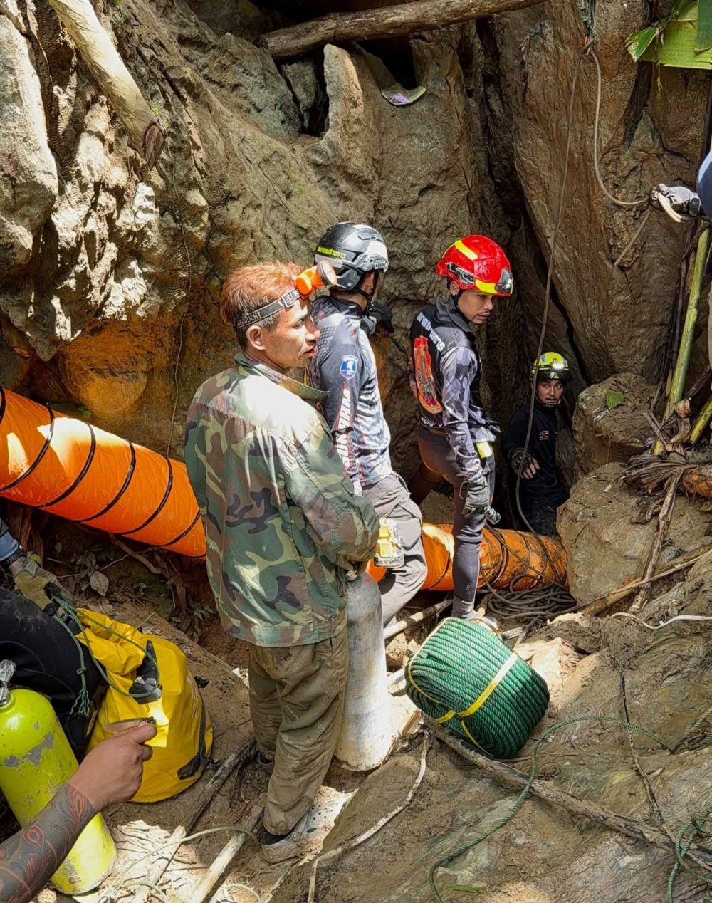 Rescuers race to reach 7 trapped in a Laos cave after flash floods block exit
