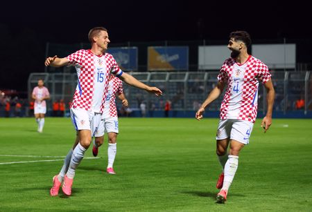 Soccer-Croatia head to World Cup on high after late 2-1 win over Slovenia