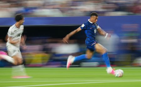 Soccer-Mbappe double sends France into knockout rounds after lengthy weather delay